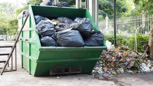 Worker putting on PPE before commercial waste collection